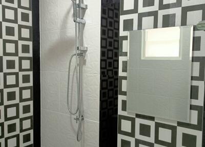 Modern bathroom with patterned tiles and shower