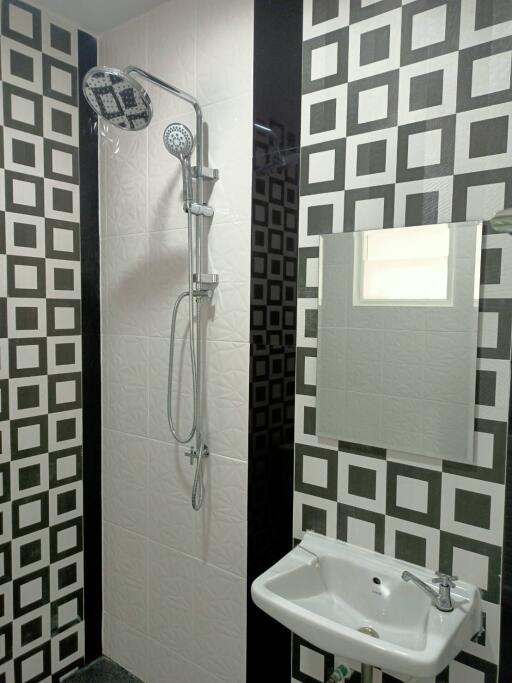 Modern bathroom with patterned tiles and shower