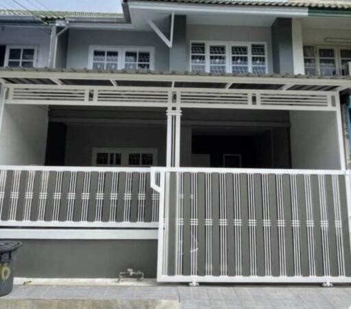 Front view of a residential building with a gated entrance