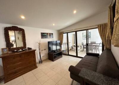 Spacious living room with modern decor and sliding glass doors to a balcony