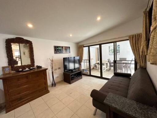 Spacious living room with modern decor and sliding glass doors to a balcony