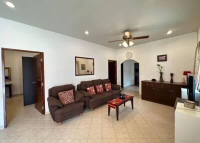 Spacious living room with seating and ceiling fan