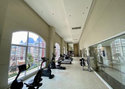 Spacious fitness center with modern exercise equipment and large windows