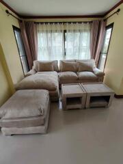 Cozy living room with large windows and beige furniture