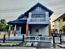 Two-story house with pitched roof and balcony