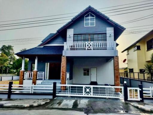 Two-story house with pitched roof and balcony