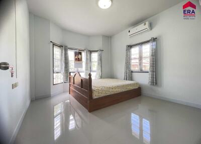 Spacious bedroom with windows and modern decor