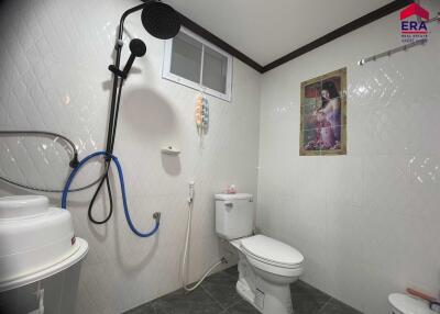 Bathroom with washing machine and modern shower setup