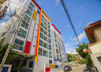 Modern multi-story apartment building with colorful accents