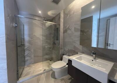 Modern bathroom with a walk-in shower and large mirror