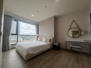 Modern bedroom with large window and city view