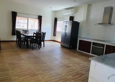 Spacious open-plan kitchen and dining area with modern appliances