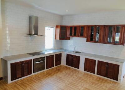 Spacious kitchen with modern appliances and wooden cabinetry