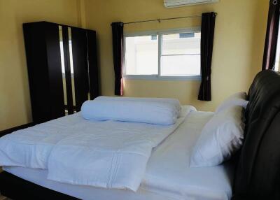 Comfortable bedroom with double bed, window, and wardrobe