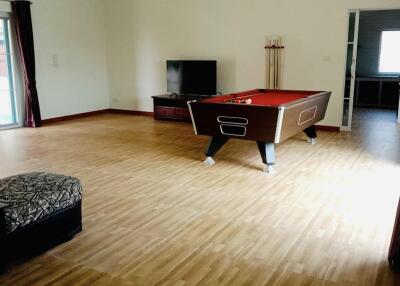 Spacious living room with pool table