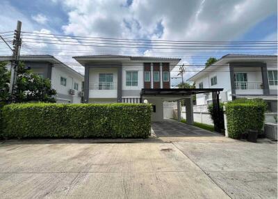 Front view of a modern two-story house with carport