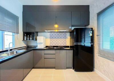 Modern kitchen with grey cabinetry and black appliances