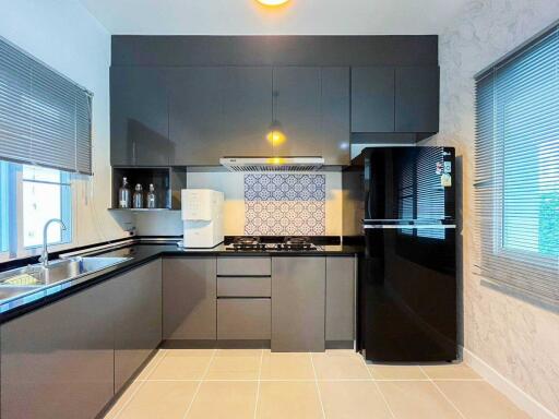 Modern kitchen with grey cabinetry and black appliances