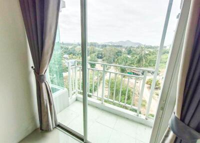 Balcony view with sliding glass door and curtains