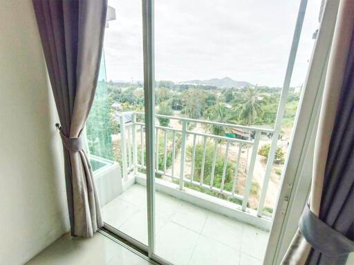 Balcony view with sliding glass door and curtains