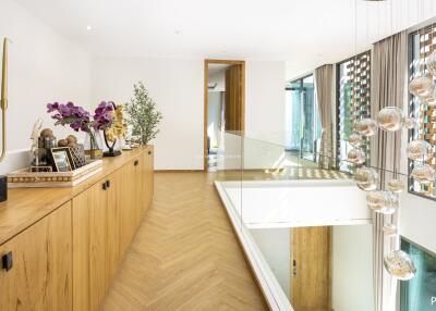 Modern hallway with decorative items and glass railing