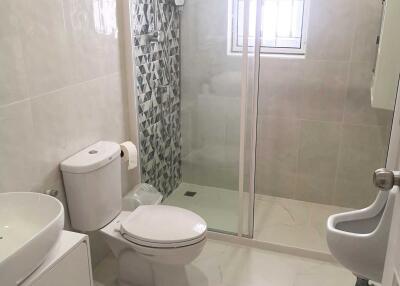 Modern bathroom with shower, toilet, and sink