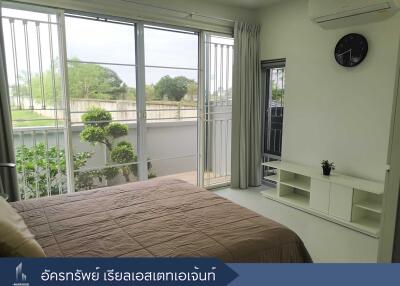 Bedroom with large windows and scenic view