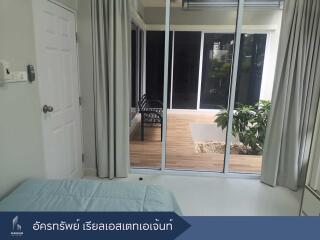 Bedroom with sliding glass doors leading to a patio