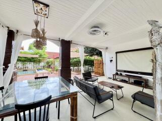 covered outdoor living area with seating and dining space