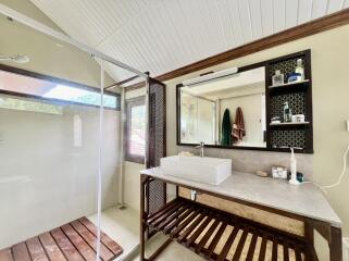 Modern bathroom with glass shower and wooden accents