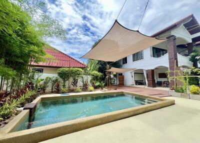 Outdoor area with swimming pool and shaded patio