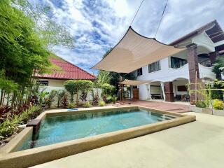 Outdoor area with swimming pool and shaded patio