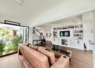 Spacious and modern living room with entertainment center and large windows