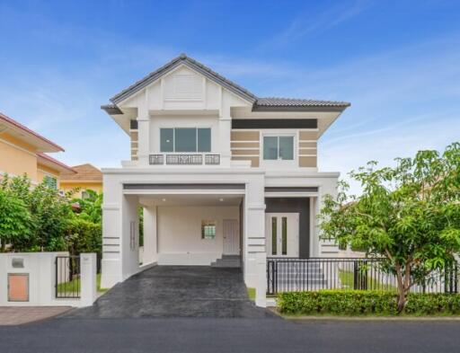 Modern two-story house with a driveway and landscaped front yard