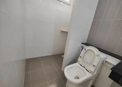 Modern bathroom with tiled floors and a toilet