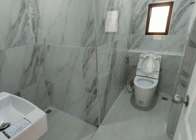 Modern bathroom with marble walls and fixtures