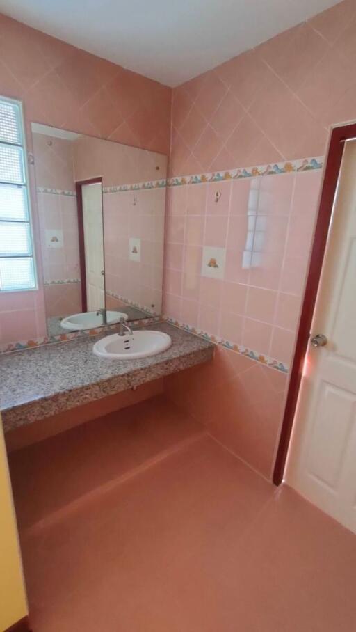 Bathroom with sink and large mirror