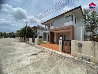 Front view of a modern house with driveway and gate