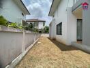 Exterior view of a white residential building with lawn