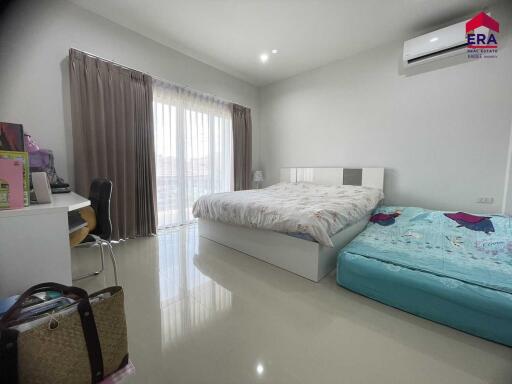 Modern bedroom with large bed and additional child