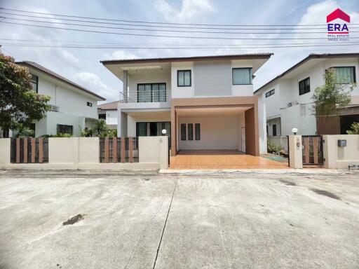 Front view of a modern two-story house with a tiled driveway