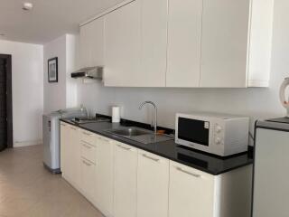 Modern kitchen with white cabinets and black countertops