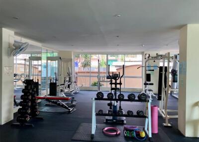 Spacious apartment gym with various fitness equipment