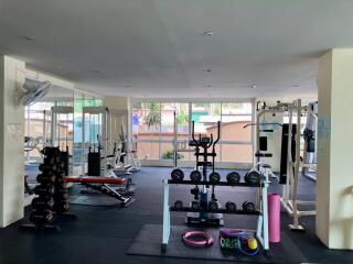 Spacious apartment gym with various fitness equipment