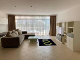 Spacious living room with modern furniture and large windows