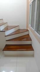 Modern wooden staircase with window