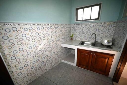 Small kitchen with patterned tiles and countertop