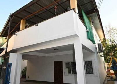 Two-story building with garage and balcony