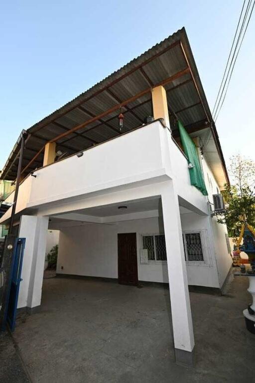 Two-story building with garage and balcony