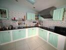 Modern kitchen with pastel green cabinets and tiled backsplash